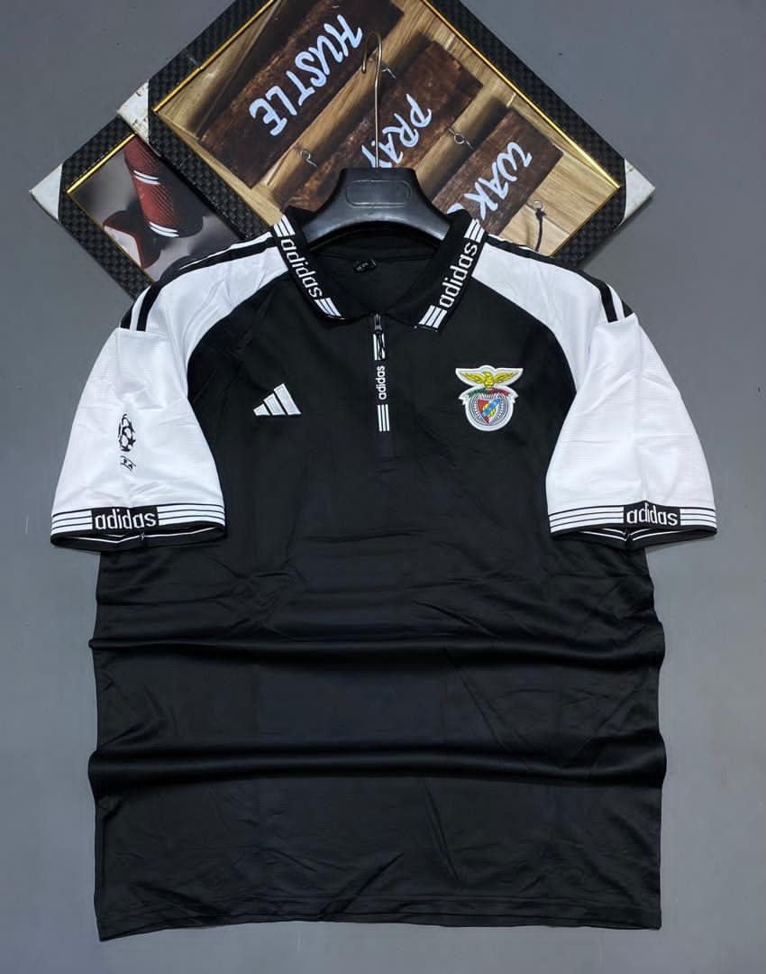 Black and white Adidas Benfica soccer jersey on hanger displaying crest and logos.