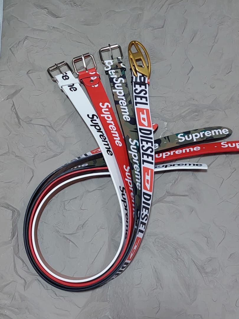 Assorted Supreme and Diesel belts in various colors and designs.
