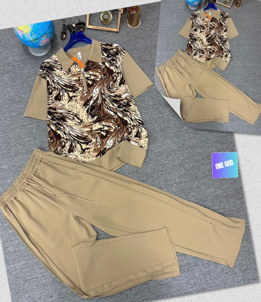 Beige two-piece set with brown and cream marble print polo shirt and beige trousers.