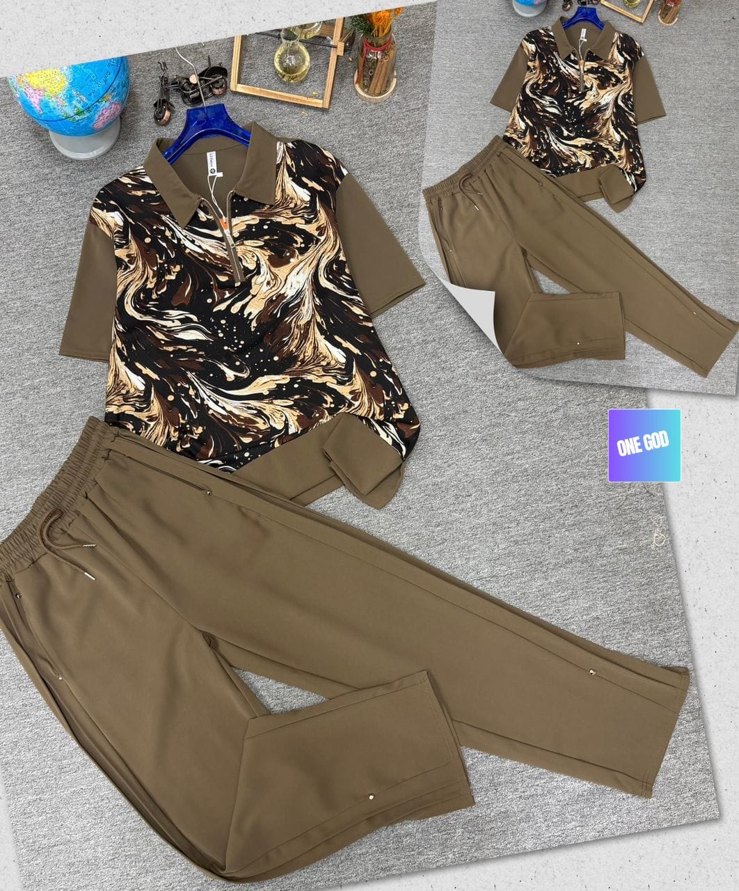 Brown two-piece set with gold and black swirl print polo shirt and brown trousers.