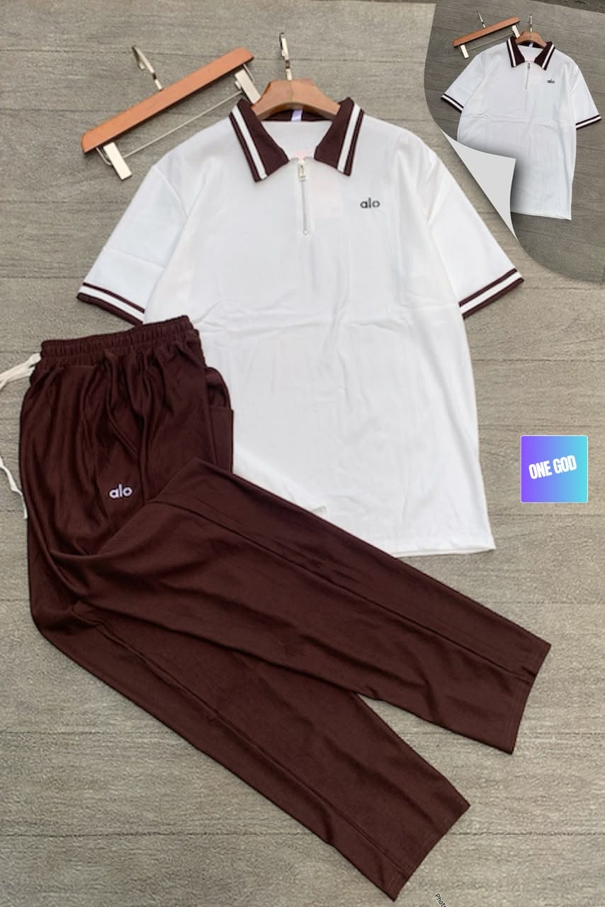 White polo top with maroon ribbed pants Alo two-piece set.