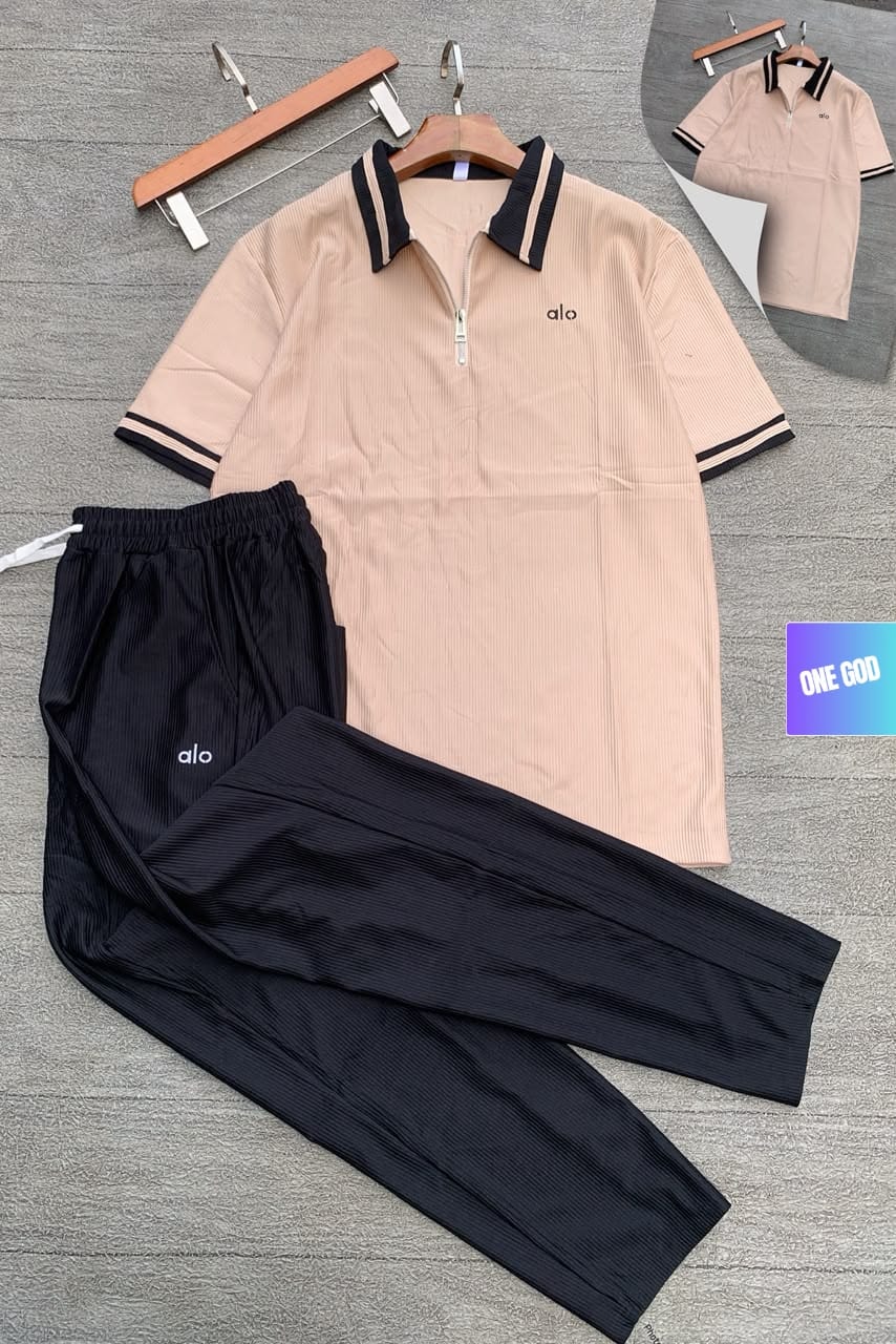 Beige polo top with black ribbed pants Alo two-piece set.