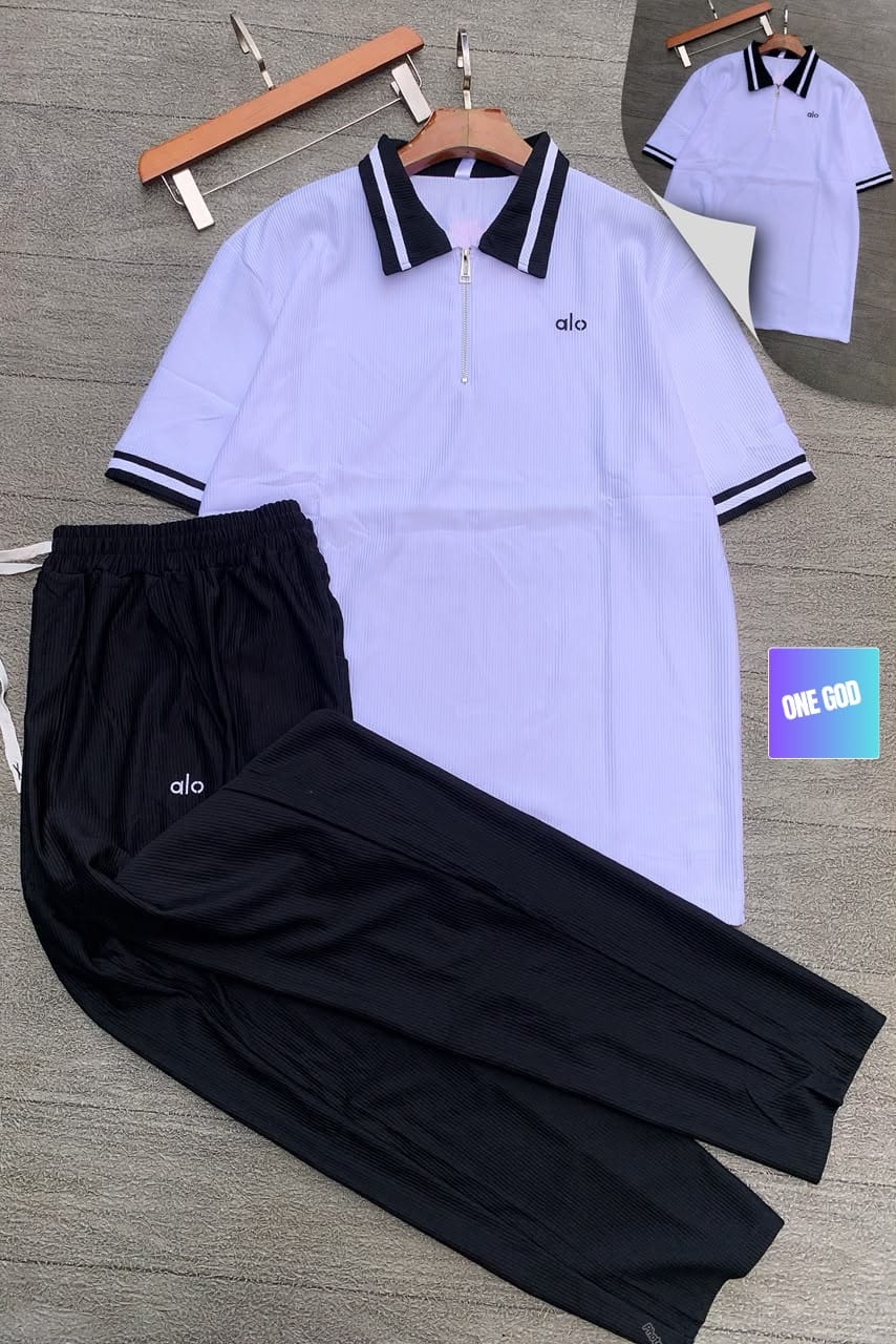 White polo top with black ribbed pants Alo two-piece set.
