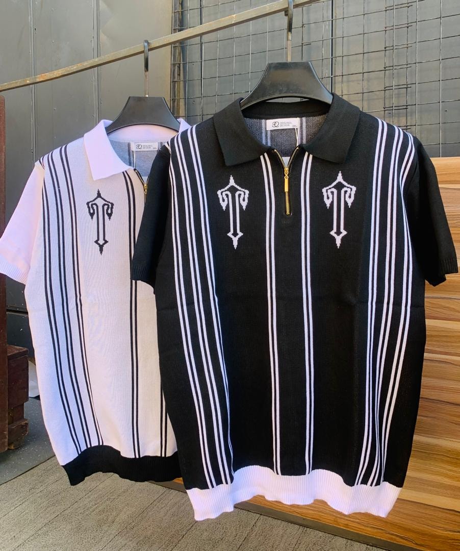 Black knit polo with white vertical stripes and embroidery shown with white and black striped version.
