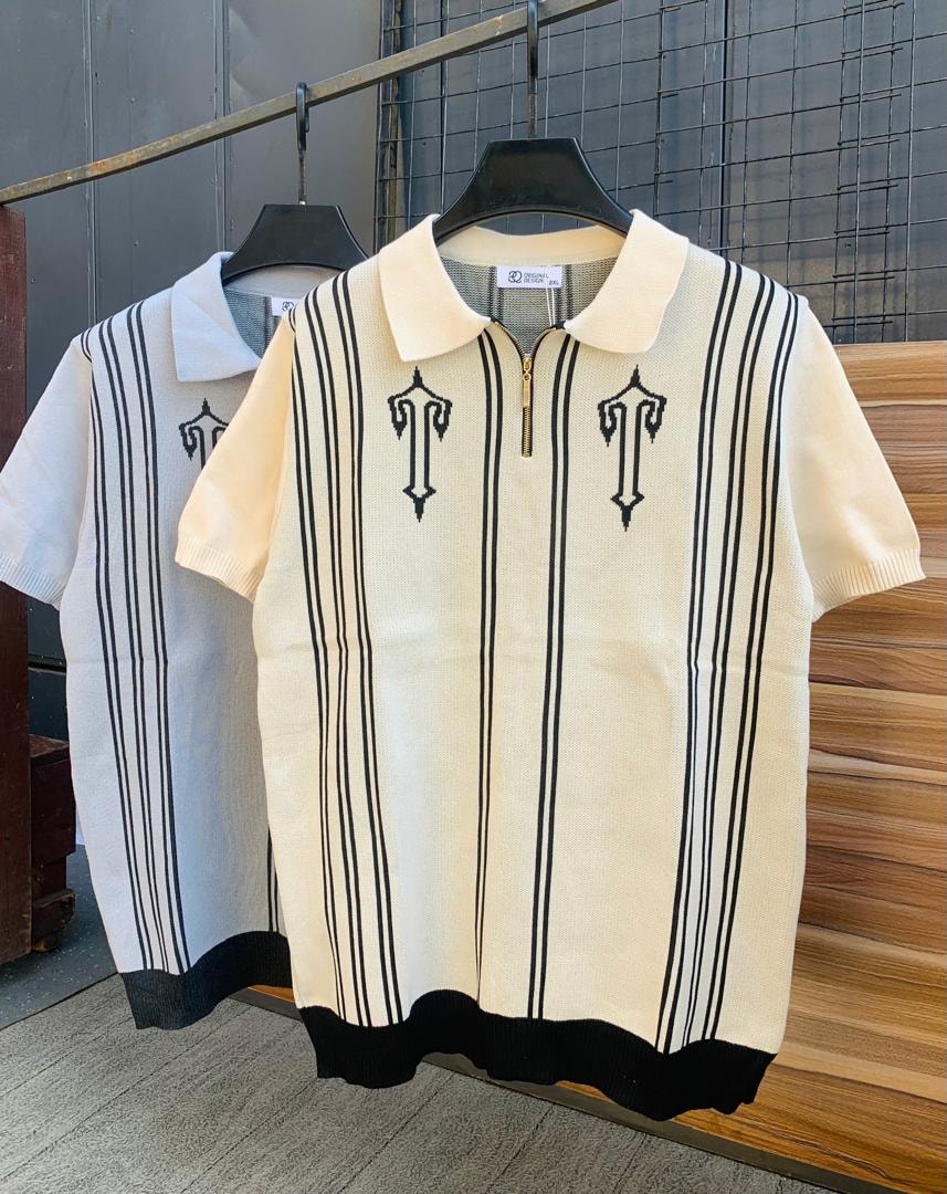 Cream and black striped knit polo shirt with embroidered motifs, zip collar and ribbed hem.