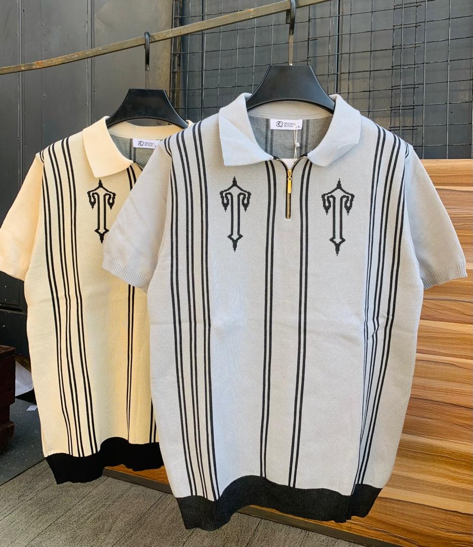 Cream knit polo with black vertical stripes and embroidery displayed next to similar cream variant.