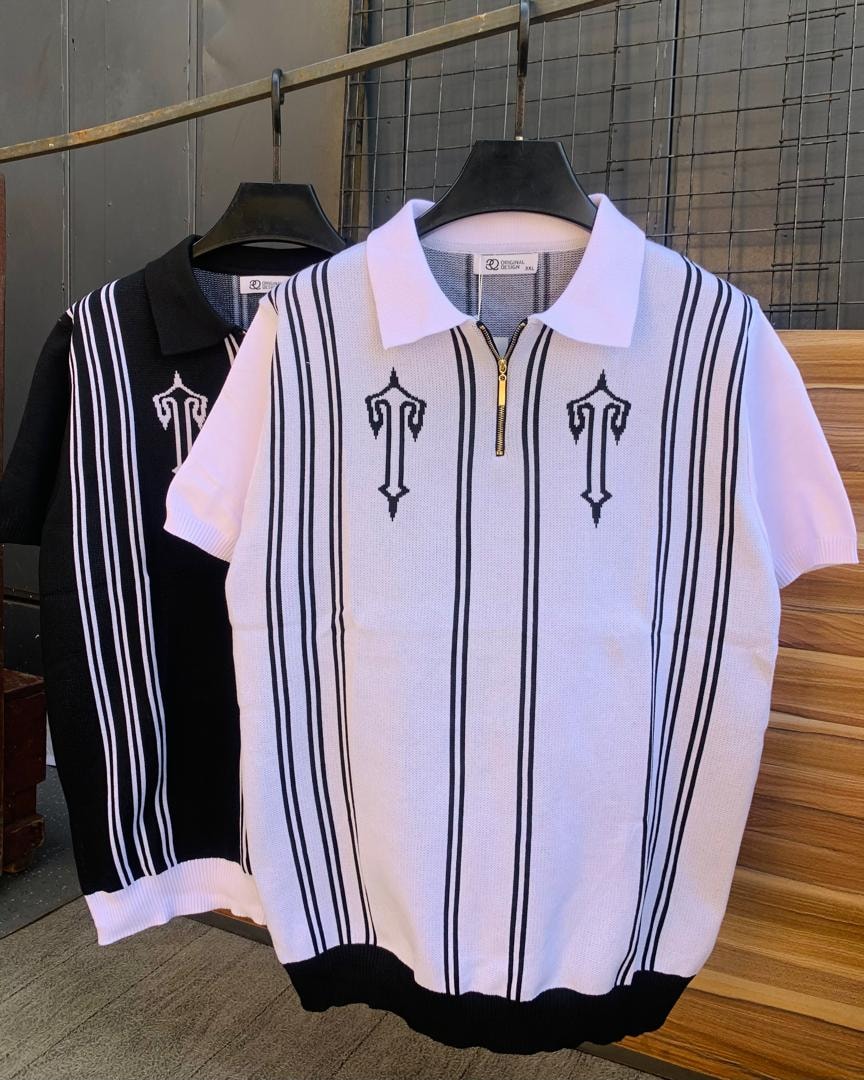 White knit polo with black vertical stripes and embroidery shown with black and white striped version.