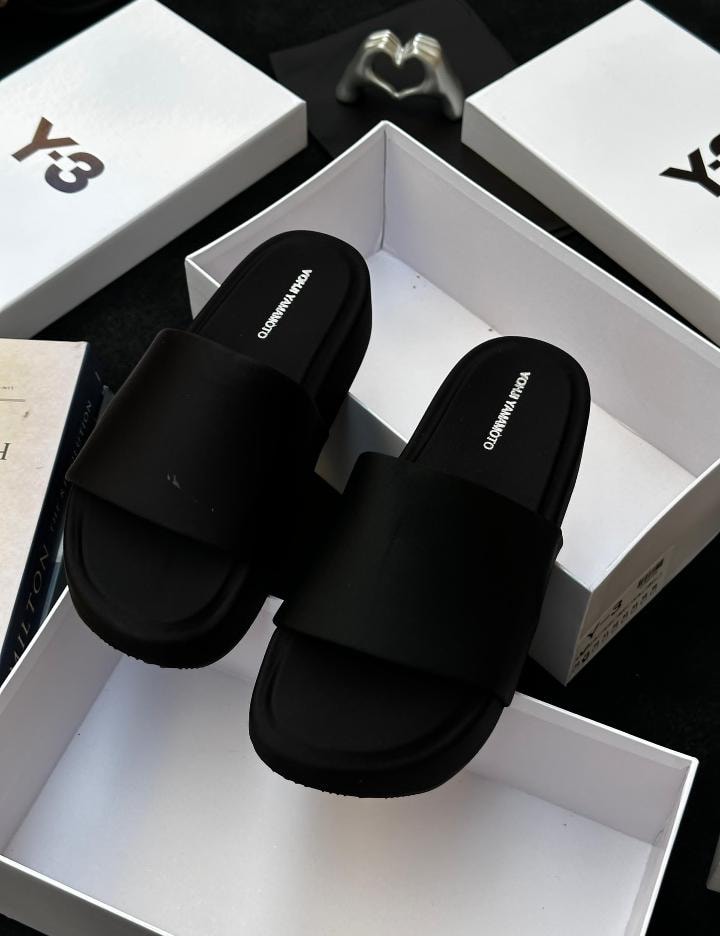 Black Y-3 platform slides with black insole displayed in white box with branding.