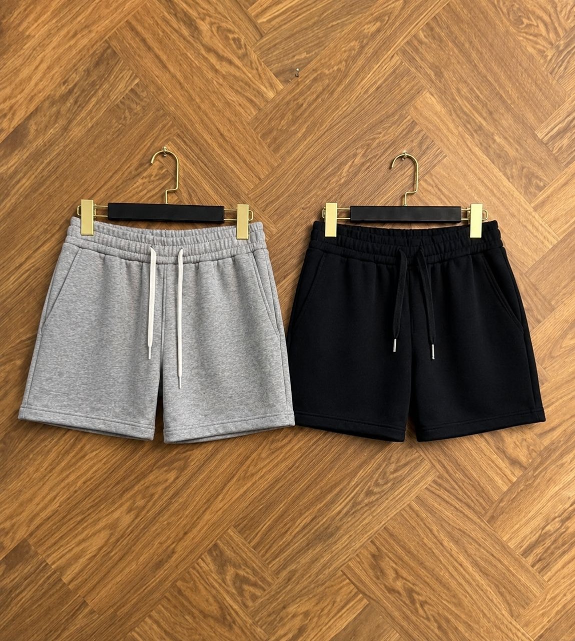 Gray and black unisex fleece shorts shown side by side.