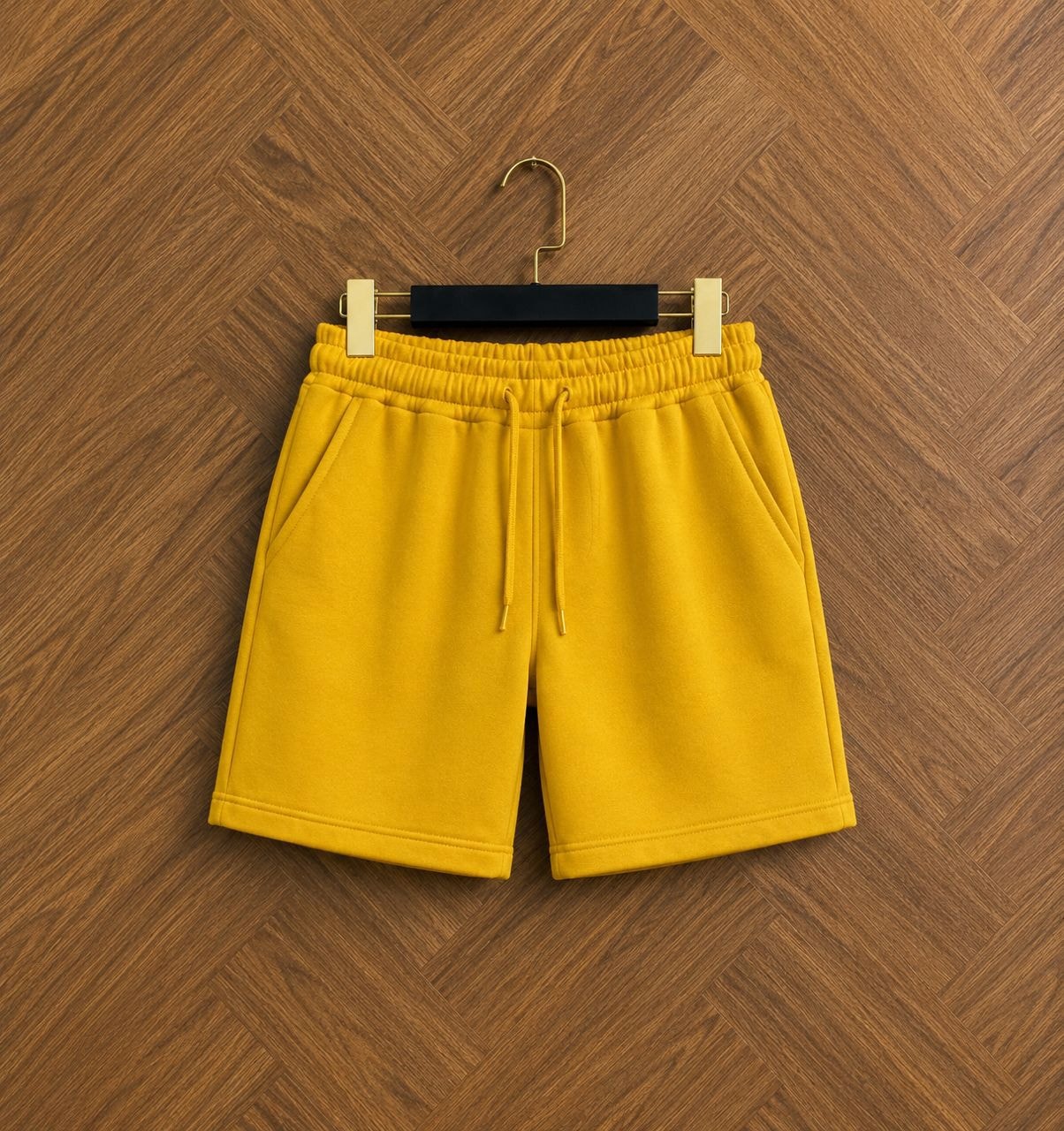 Yellow unisex fleece shorts with drawstring and pockets.