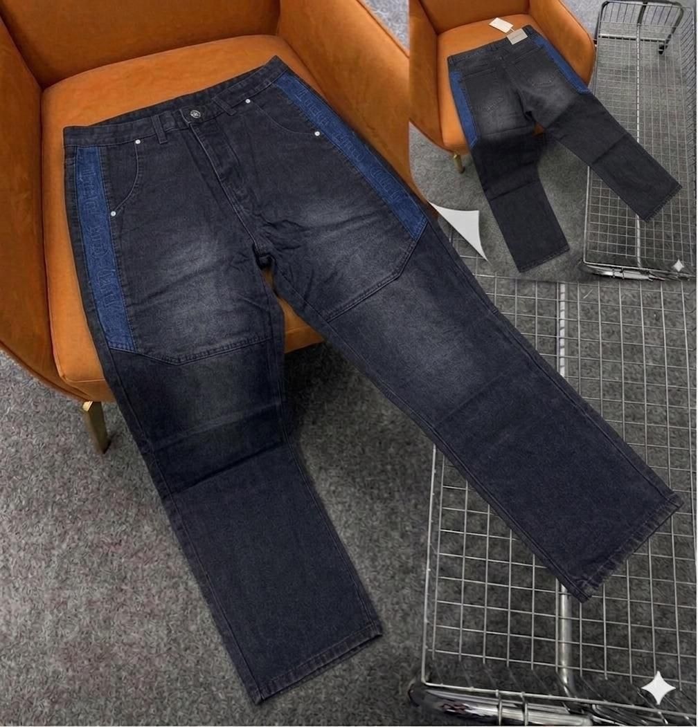 Dark jeans with blue side panels and text, shown with back view on orange chair.
