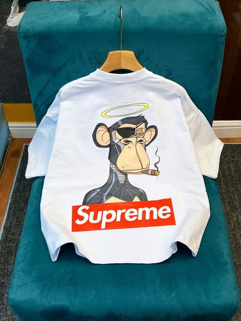 White Supreme robot monkey graphic crop top showing back view on teal chair.