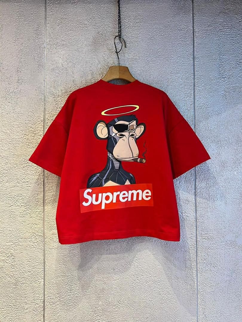 Red Supreme monkey graphic t-shirt with robot monkey, halo, cigar and Supreme logo.