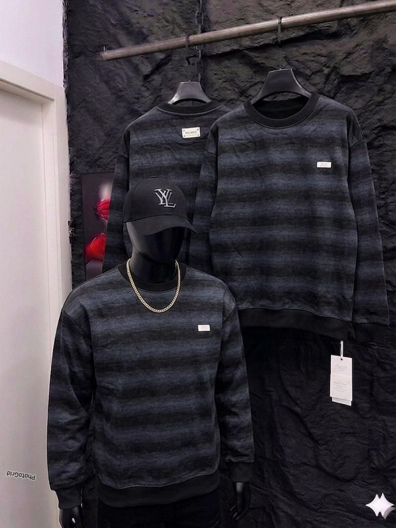 Black striped sweatshirt on mannequin and hanger with tags.