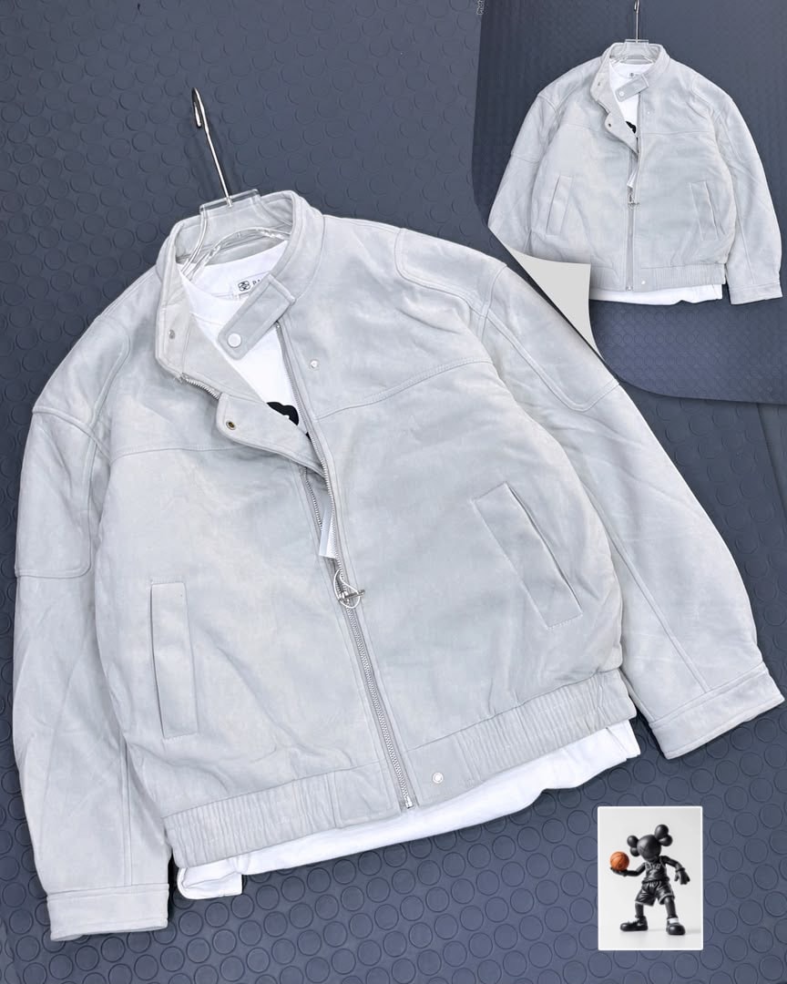 Light gray suede bomber jacket on clear hanger over white tee.