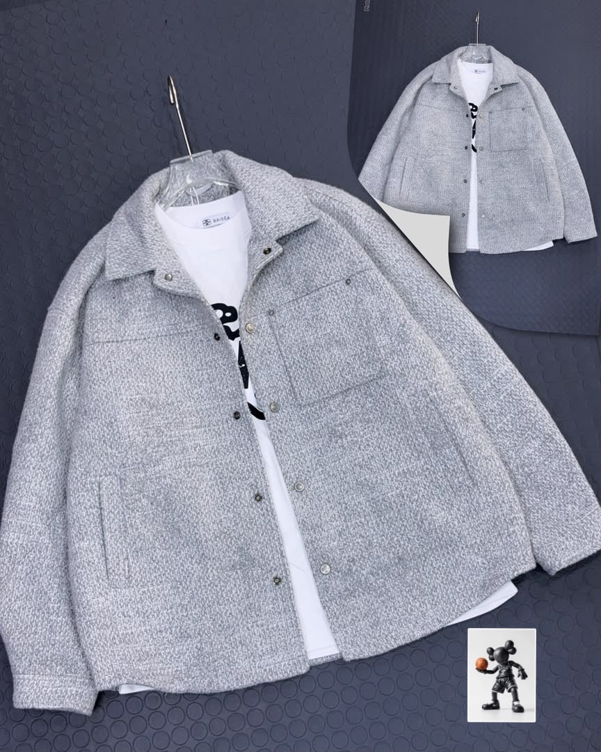 Light gray textured button-up jacket on clear hanger layered over white t-shirt.