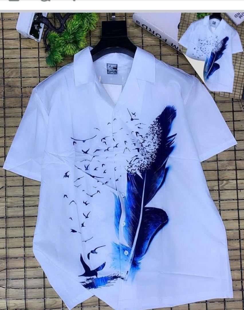 White short sleeve shirt displaying blue feather, birds and water elements print.