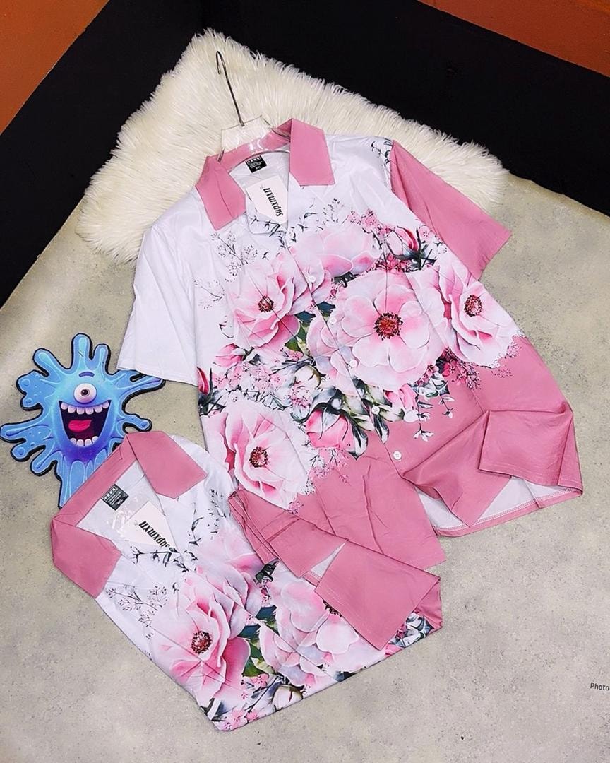 White short sleeve shirt with large pink floral prints and pink collar and sleeve accents.