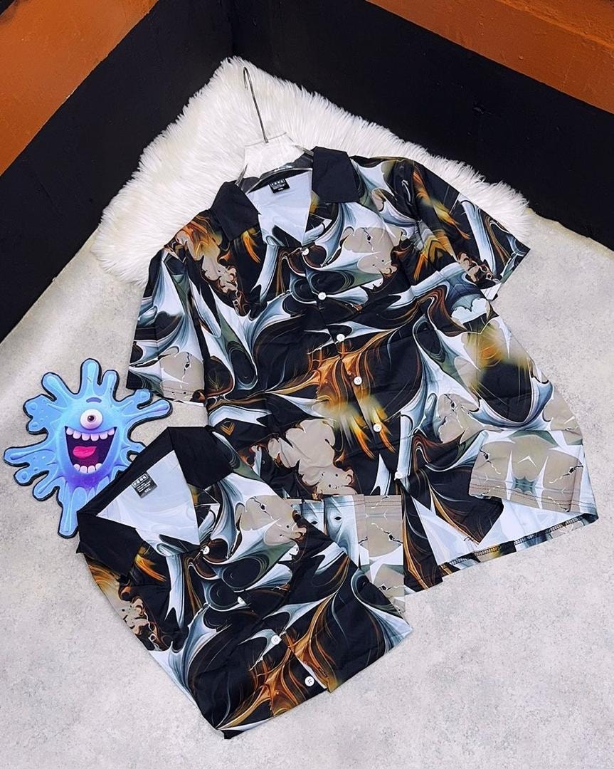 Short sleeve shirt with black, white and orange abstract marble swirl print, displayed flat.