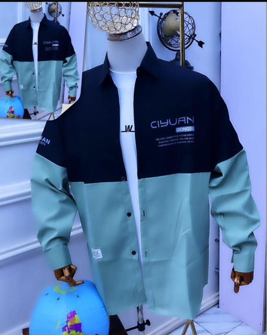 Black and mint green colorblock button-down shirt on mannequin with text prints.
