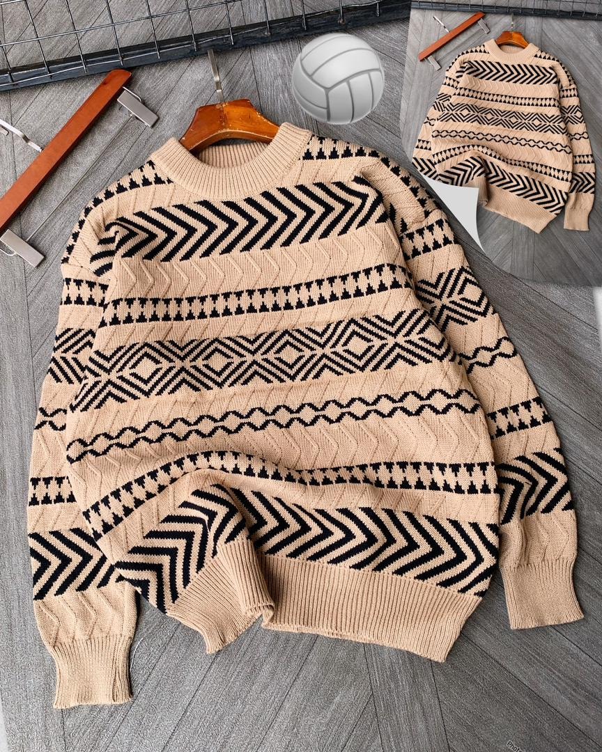 Beige geometric patterned knitted sweater on wooden hanger with volleyball and clips.