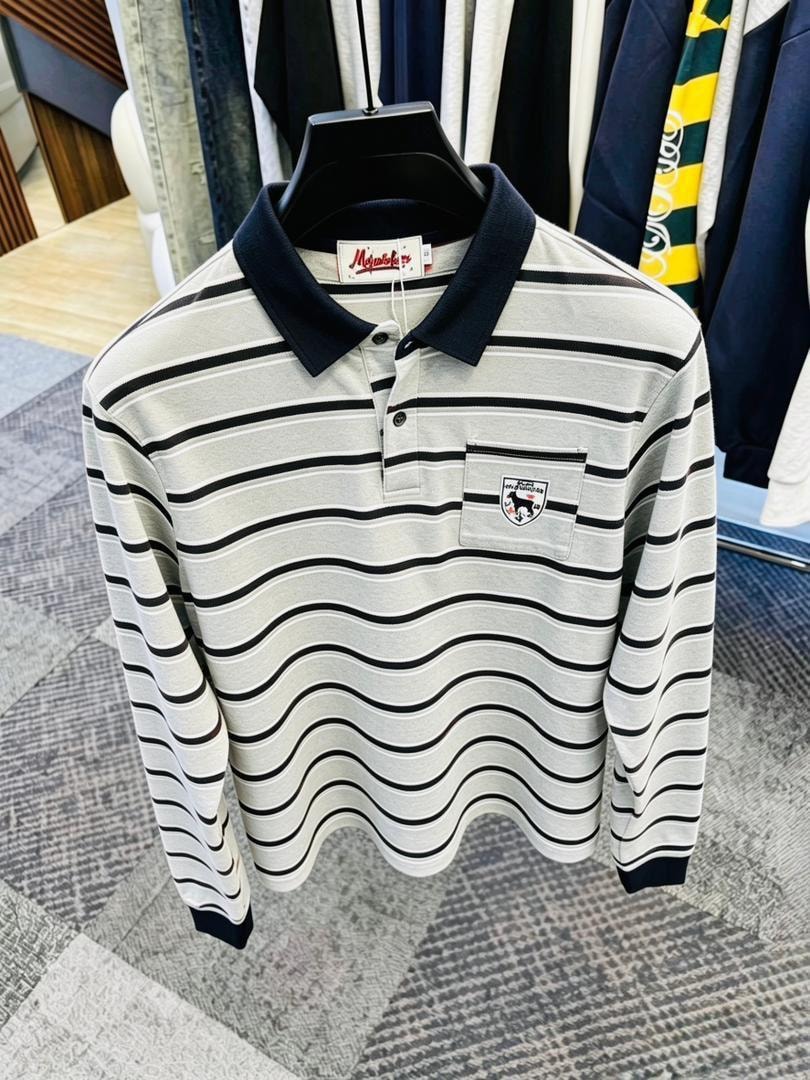 Gray and black wavy striped long sleeve polo shirt with navy collar on black hanger.