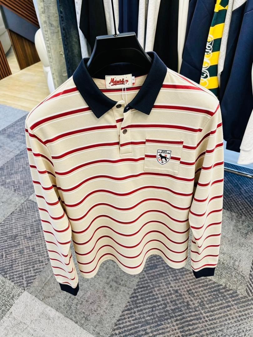 Cream and red wavy striped long sleeve polo shirt with navy collar on black hanger.