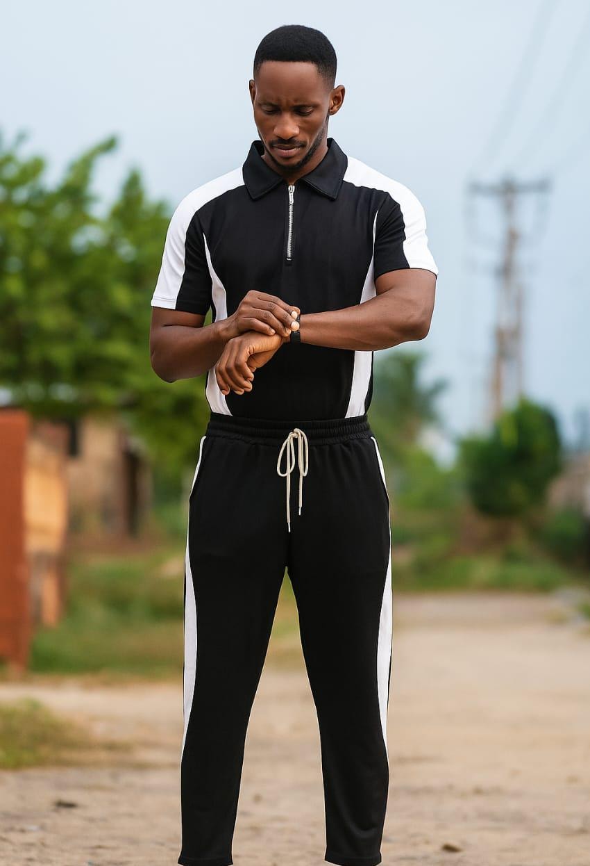 Man in black and white colorblock ribbed polo and jogger set.
