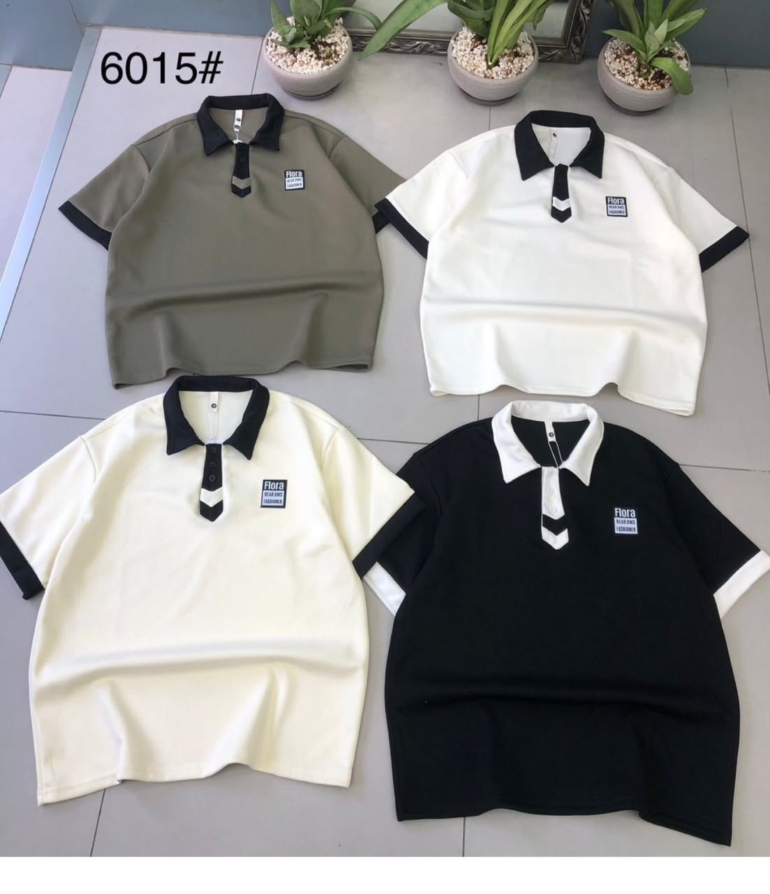 Four polo shirts in olive, white, cream and black with contrast collars, cuffs and decorative placket details.