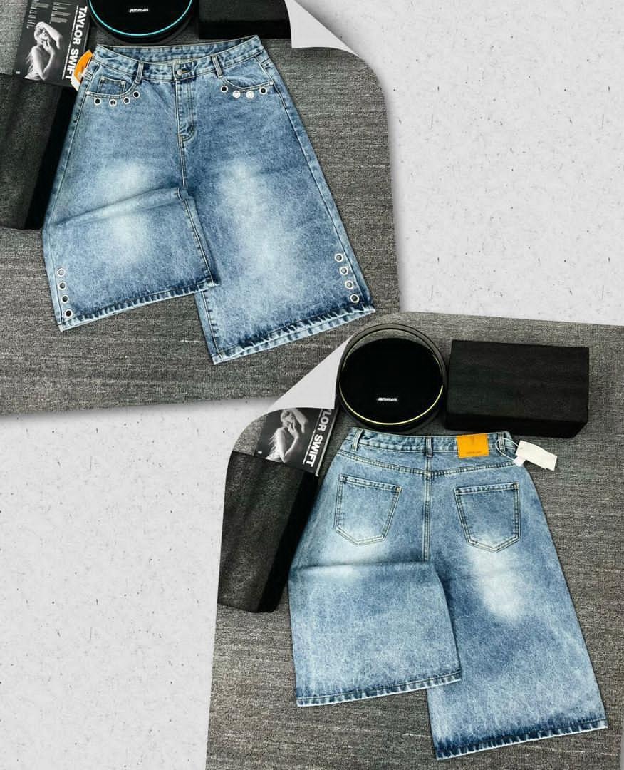 Front and back views of light blue 3/4 denim shorts with metal eyelets along seams and hem.