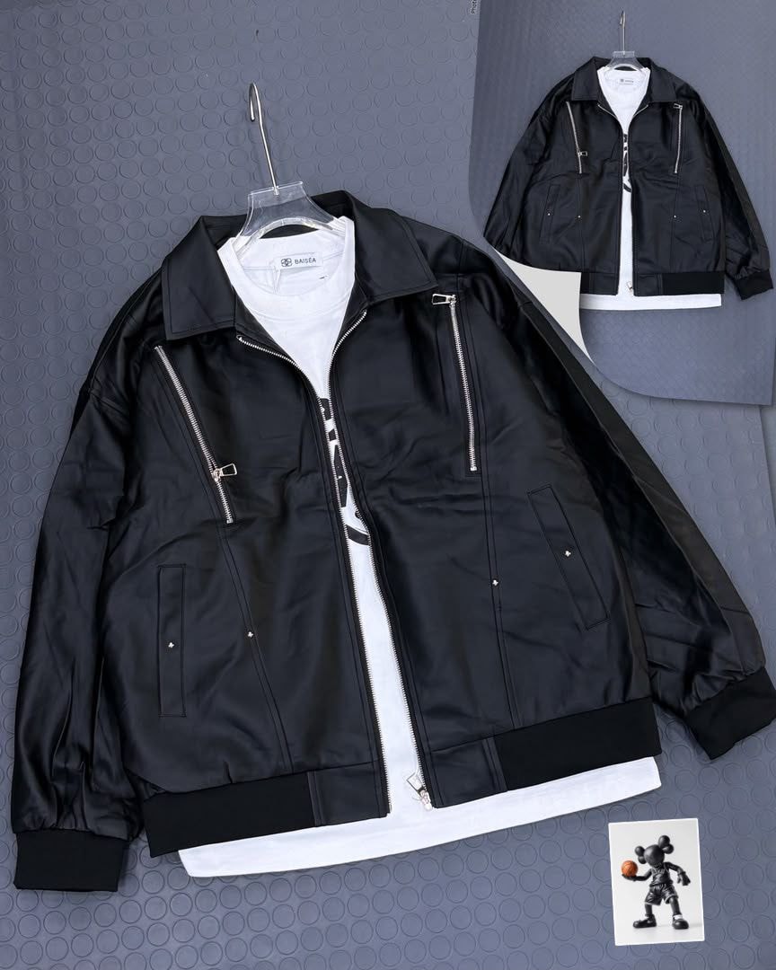 Black collared zip jacket on gray background with white tee layered underneath.