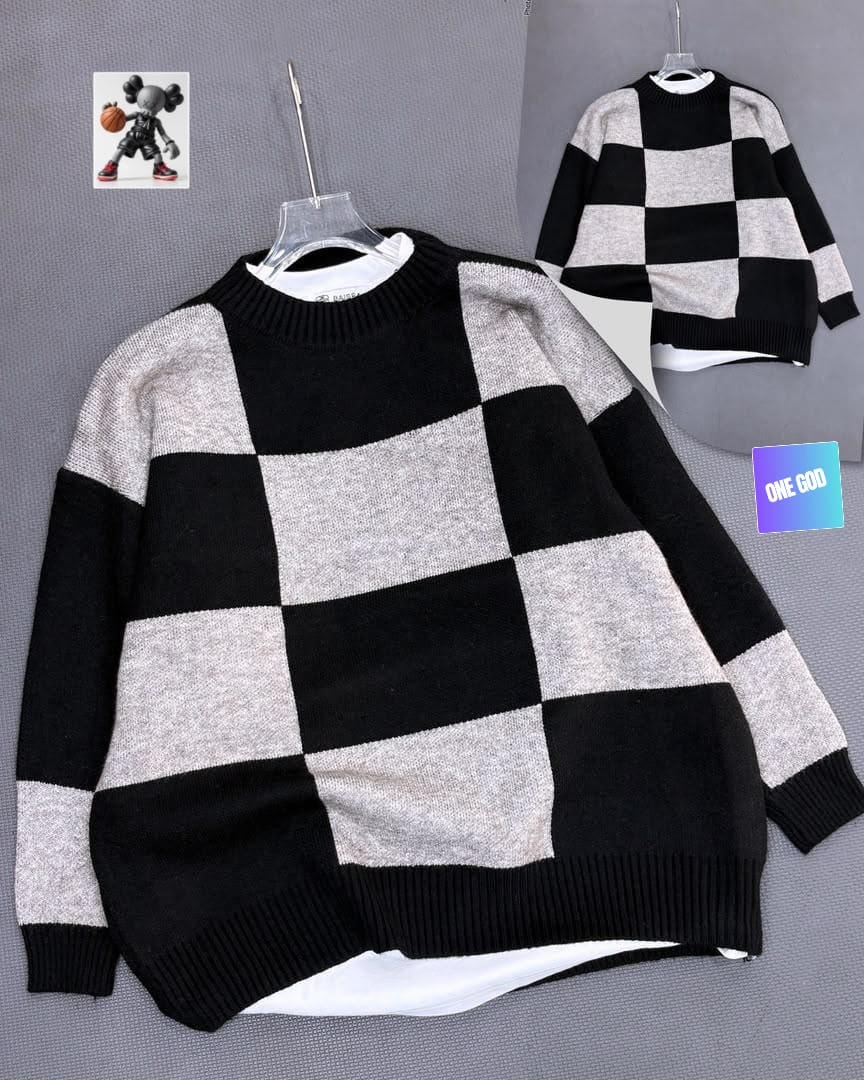 Black and gray checkered pattern knit sweatshirt on clear hanger.