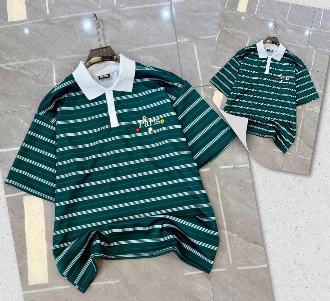 Green striped polo shirt with white collar and Paris embroidery on hanger and flat lay.