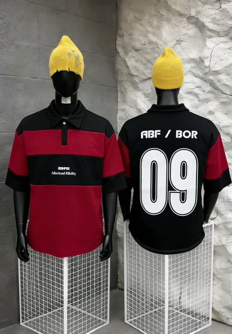 Front and back views of red and black striped polo shirt on mannequins wearing yellow beanies.