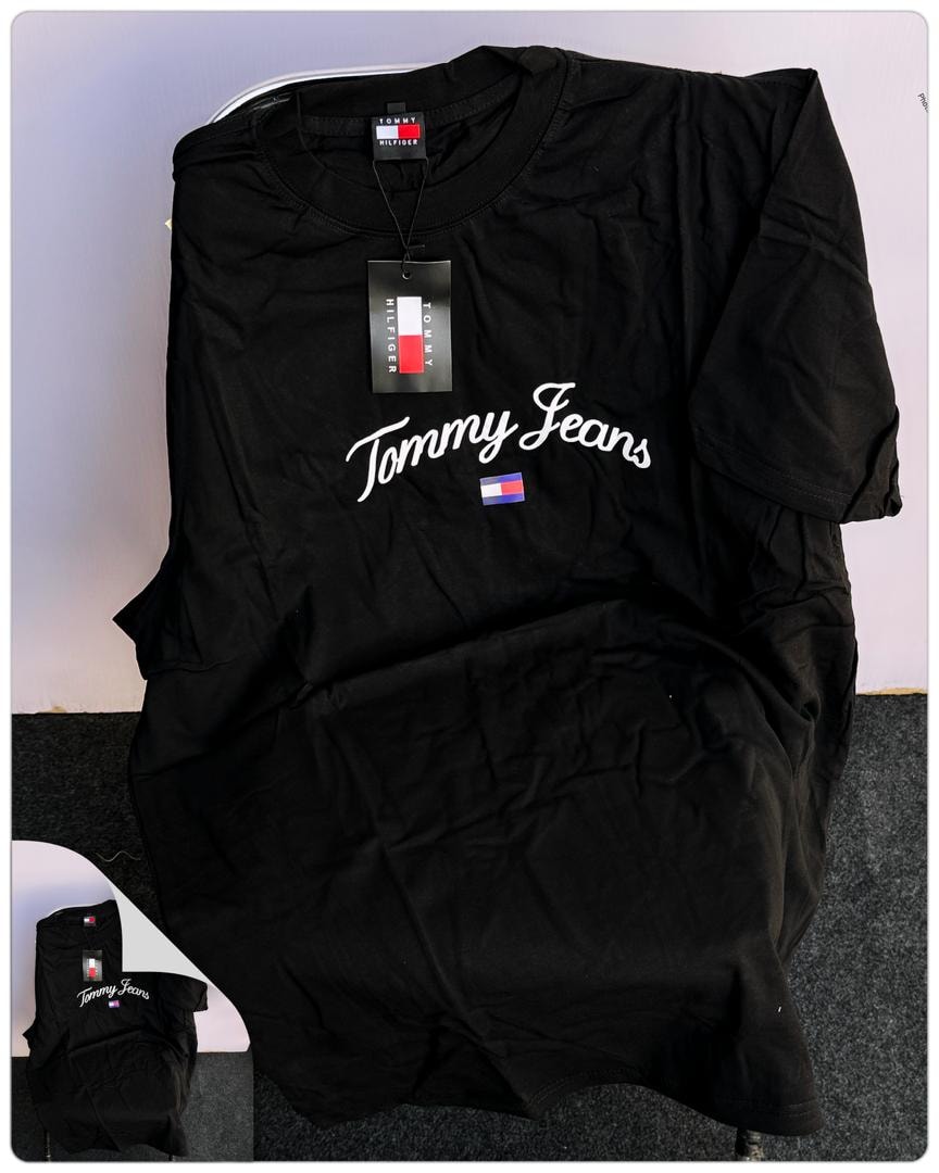 Black Tommy Jeans script round neck t-shirt laid flat with tag.