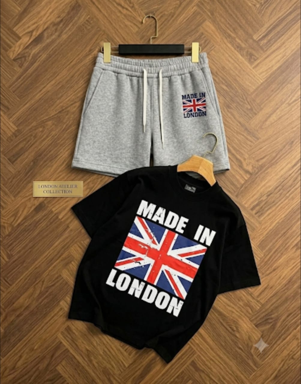 Black t-shirt with Made in London Union Jack graphic paired with gray shorts.