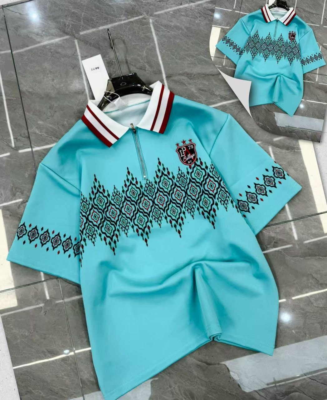 Light blue geometric print quarter-zip polo shirt with striped collar and crest logo on tiled floor.