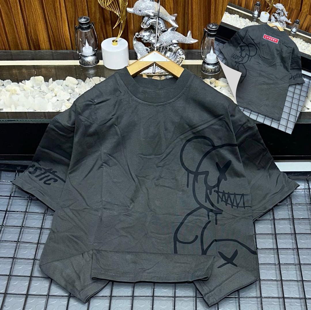 Gray oversized t-shirt with black abstract figure graphic on front and sleeve.