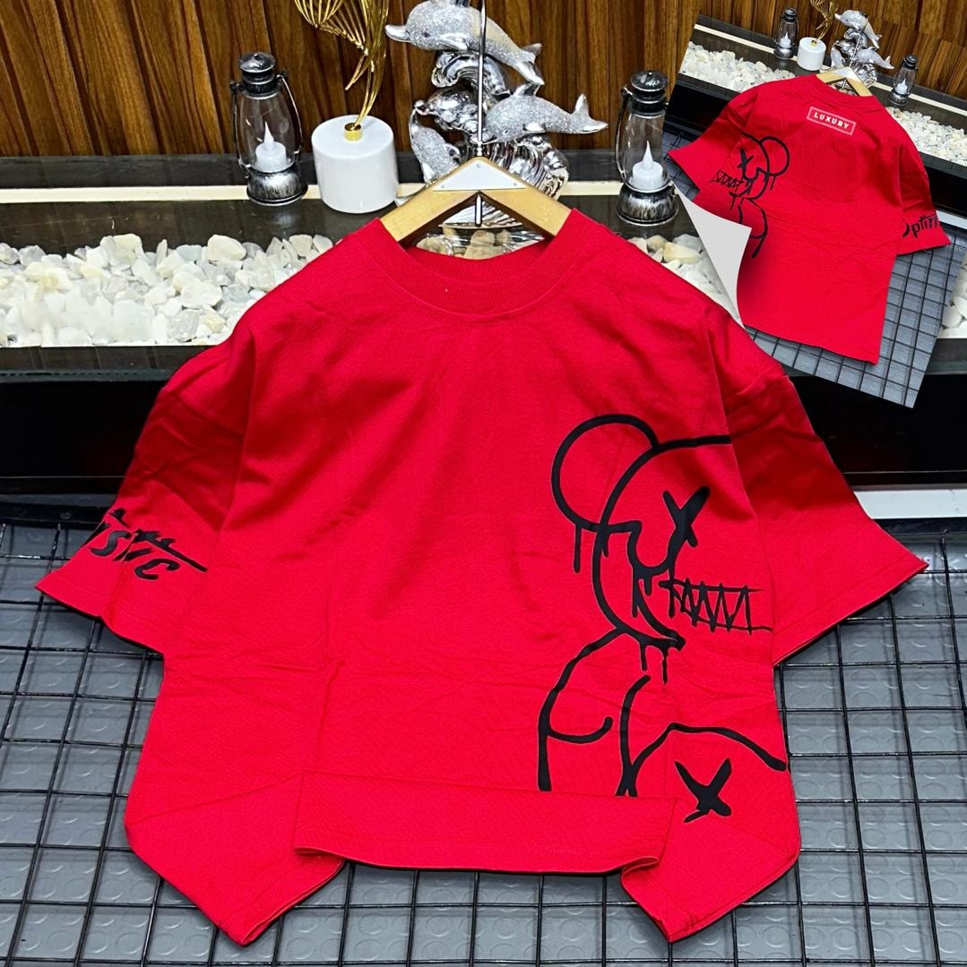 Red oversized t-shirt with black abstract figure graphic on front and sleeve.