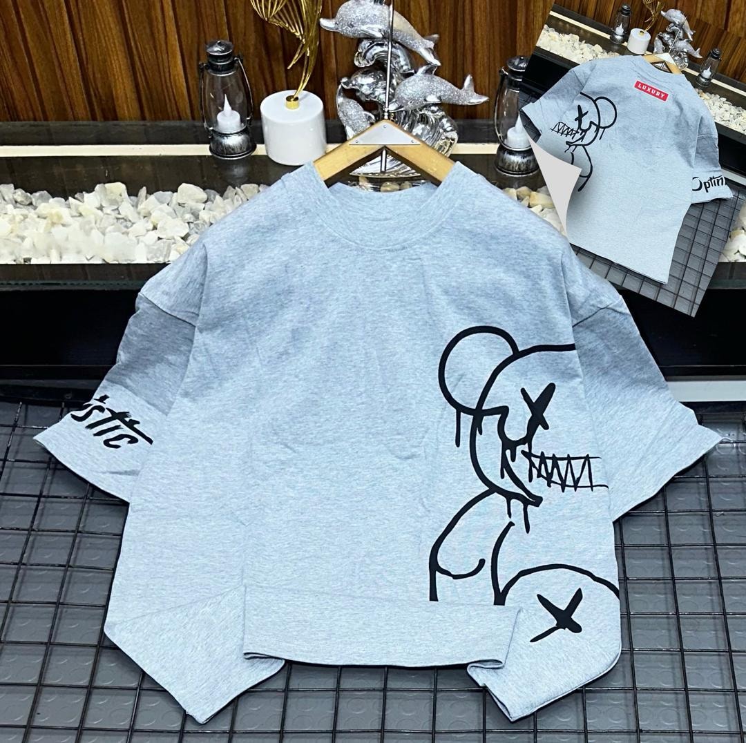 Light blue oversized t-shirt with black abstract figure graphic on front and sleeve.