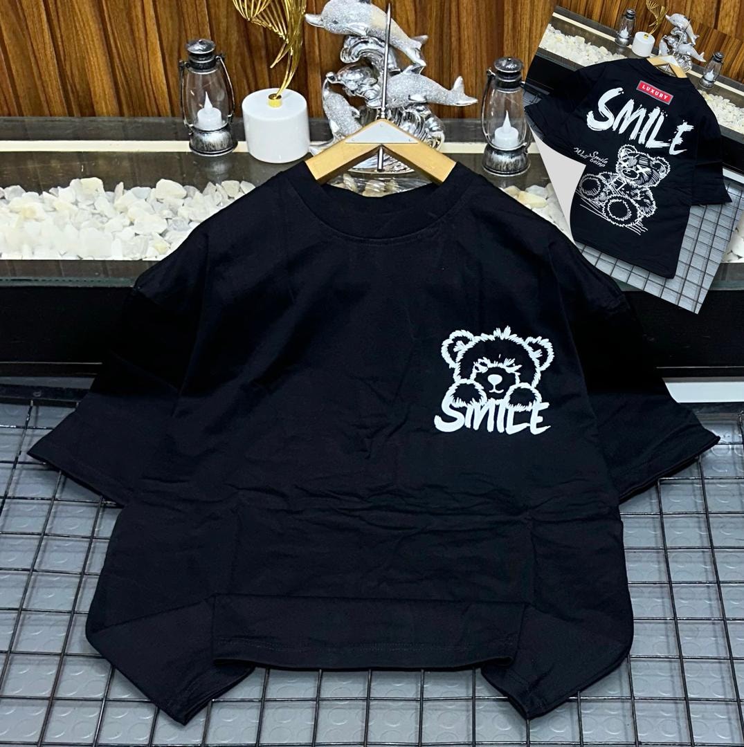 Black oversized t-shirt with white bear and SMILE graphic on chest, back view inset.