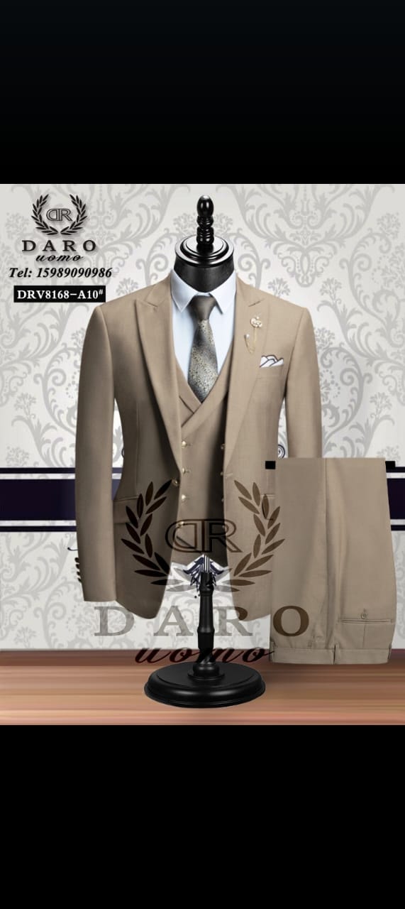 Beige three-piece suit on mannequin with trousers displayed separately.
