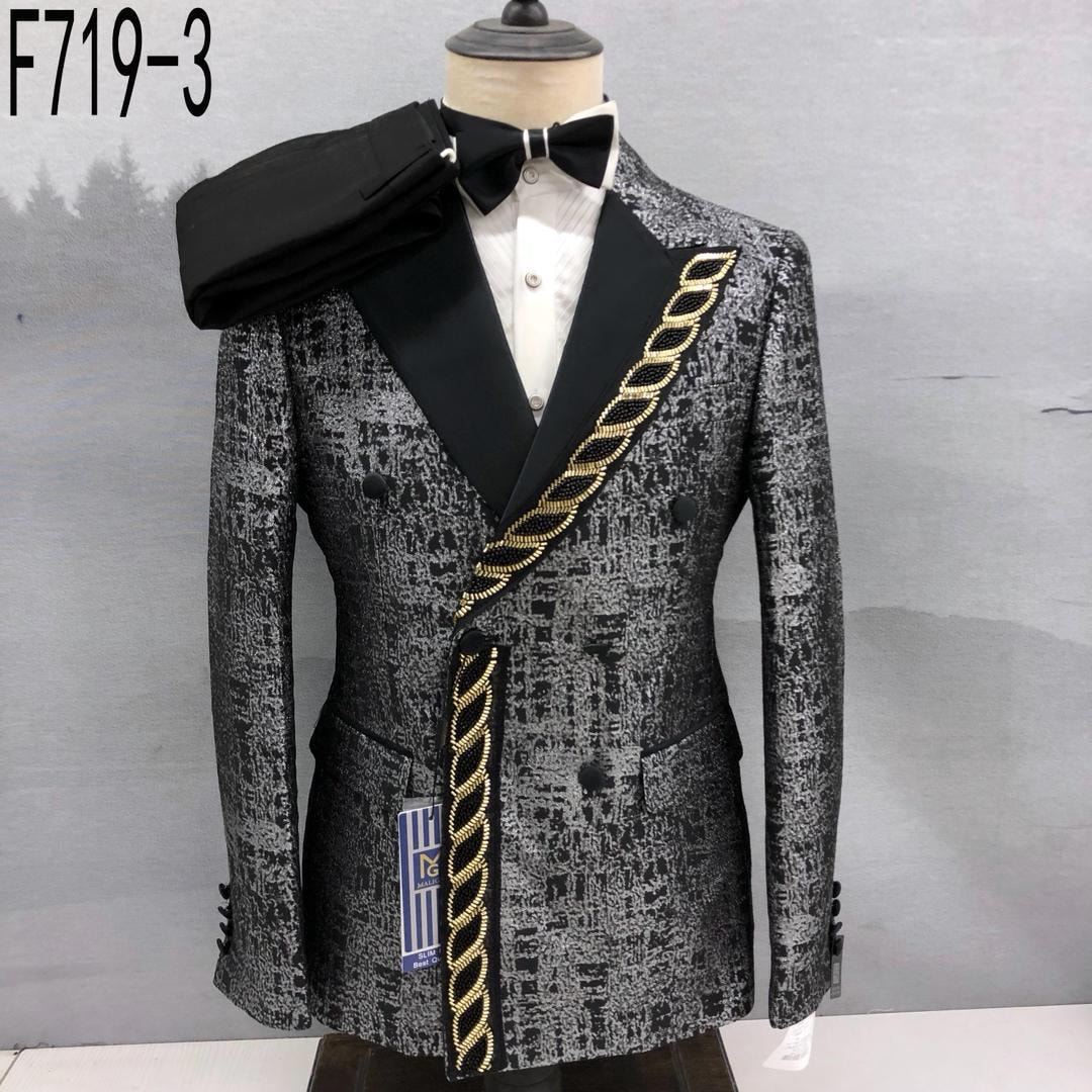 Black and gray patterned double breasted tuxedo suit with black lapels, gold chain detail, bow tie and trousers on mannequin.