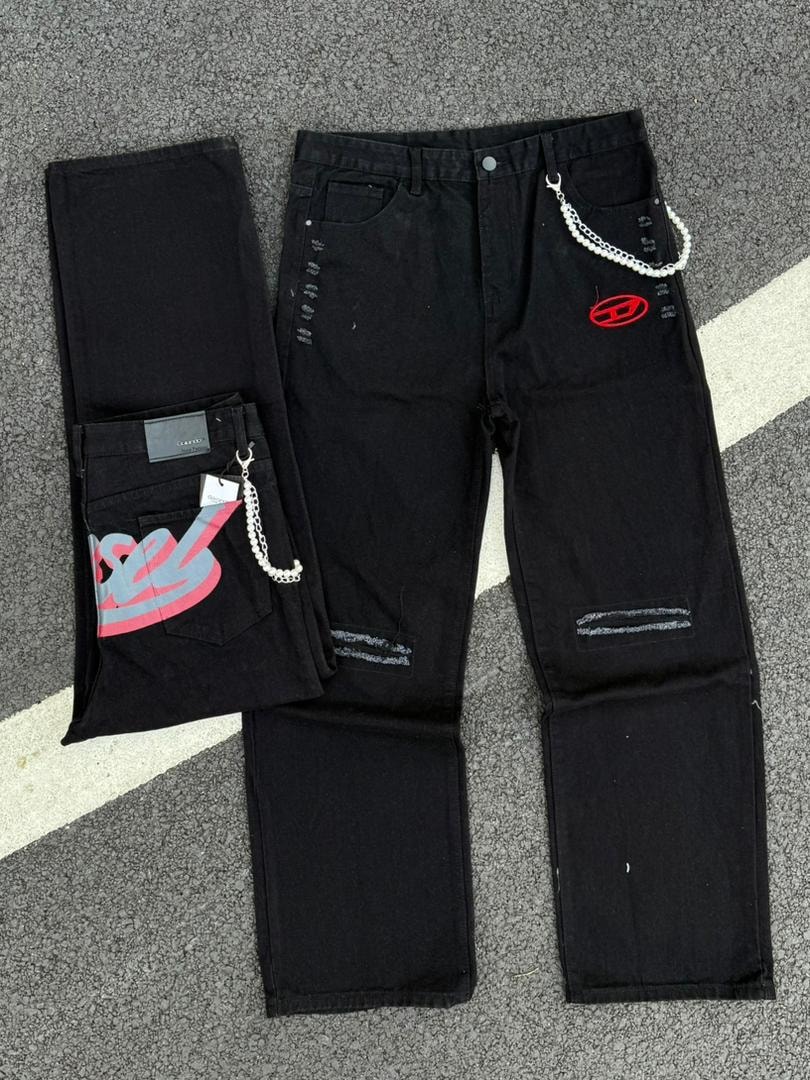Black jeans with chains, ripped knees, graphic on back pocket and red logo.