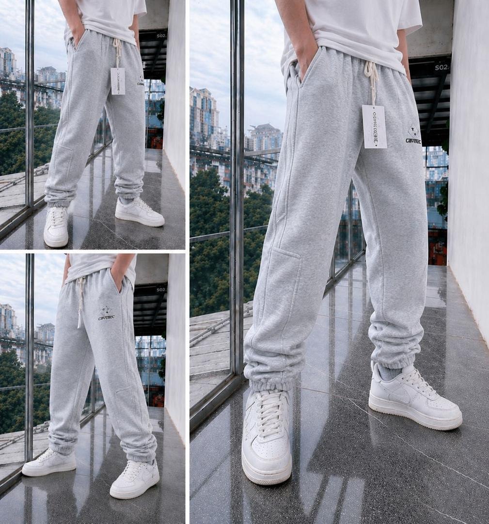 Light gray fleece joggers shown in multiple angles on a model with white t-shirt and sneakers.