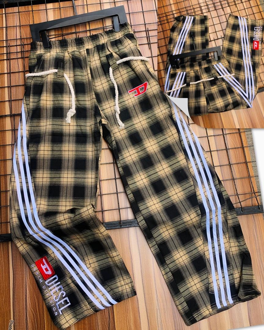 Diesel brown plaid joggers displayed with white stripes and red logo on hip.