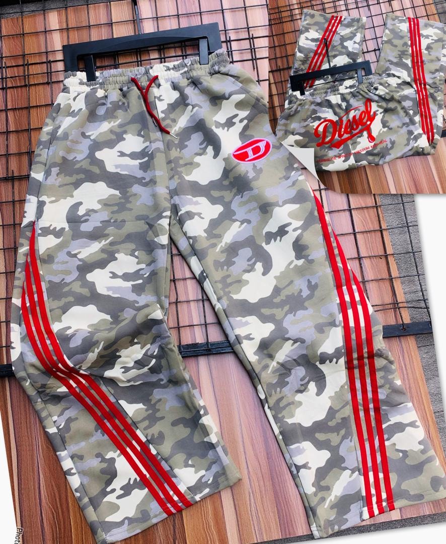 Diesel green camouflage joggers on hanger with red stripes and logo details.