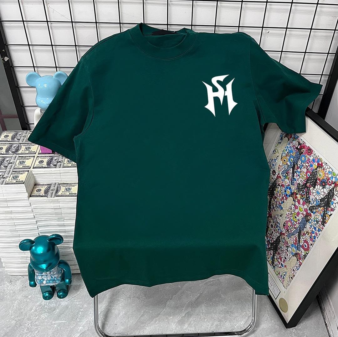 Green t-shirt with white stylized monogram logo on left chest.