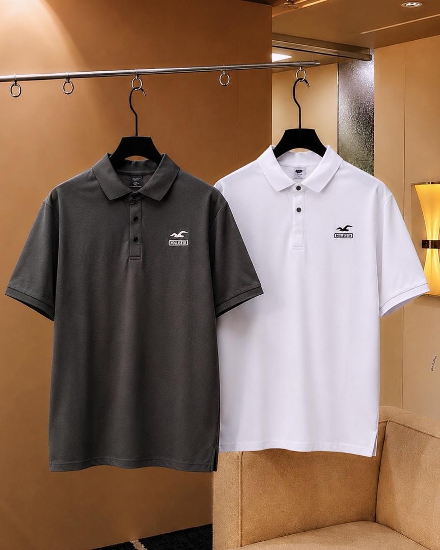 Gray and white Hollister polo shirts hanging side by side.