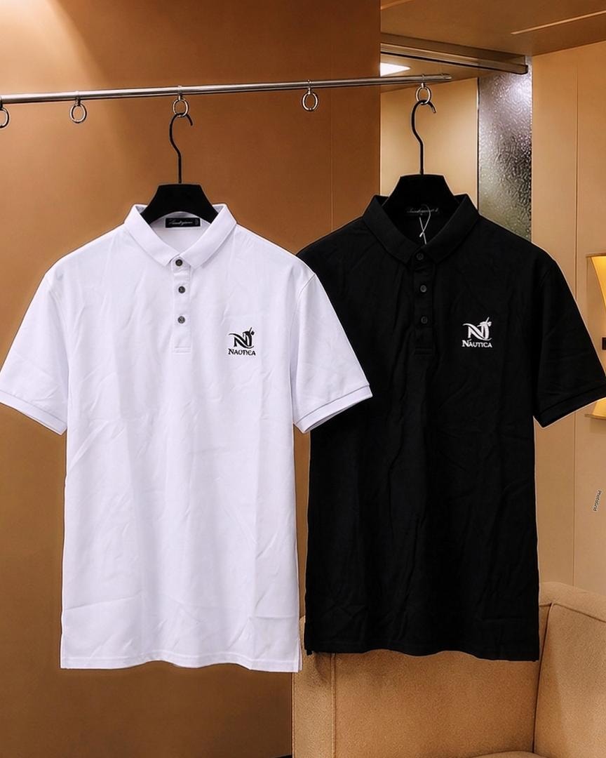 White and black Nautica polo shirts hanging side by side.